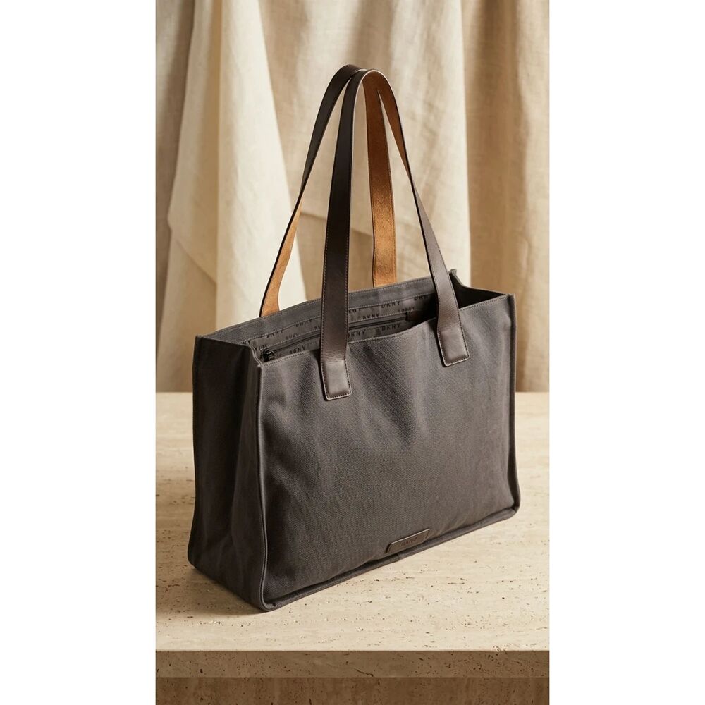 DKNY Charcoal gray Not visible on exterior; canvas body with leather handles Bag